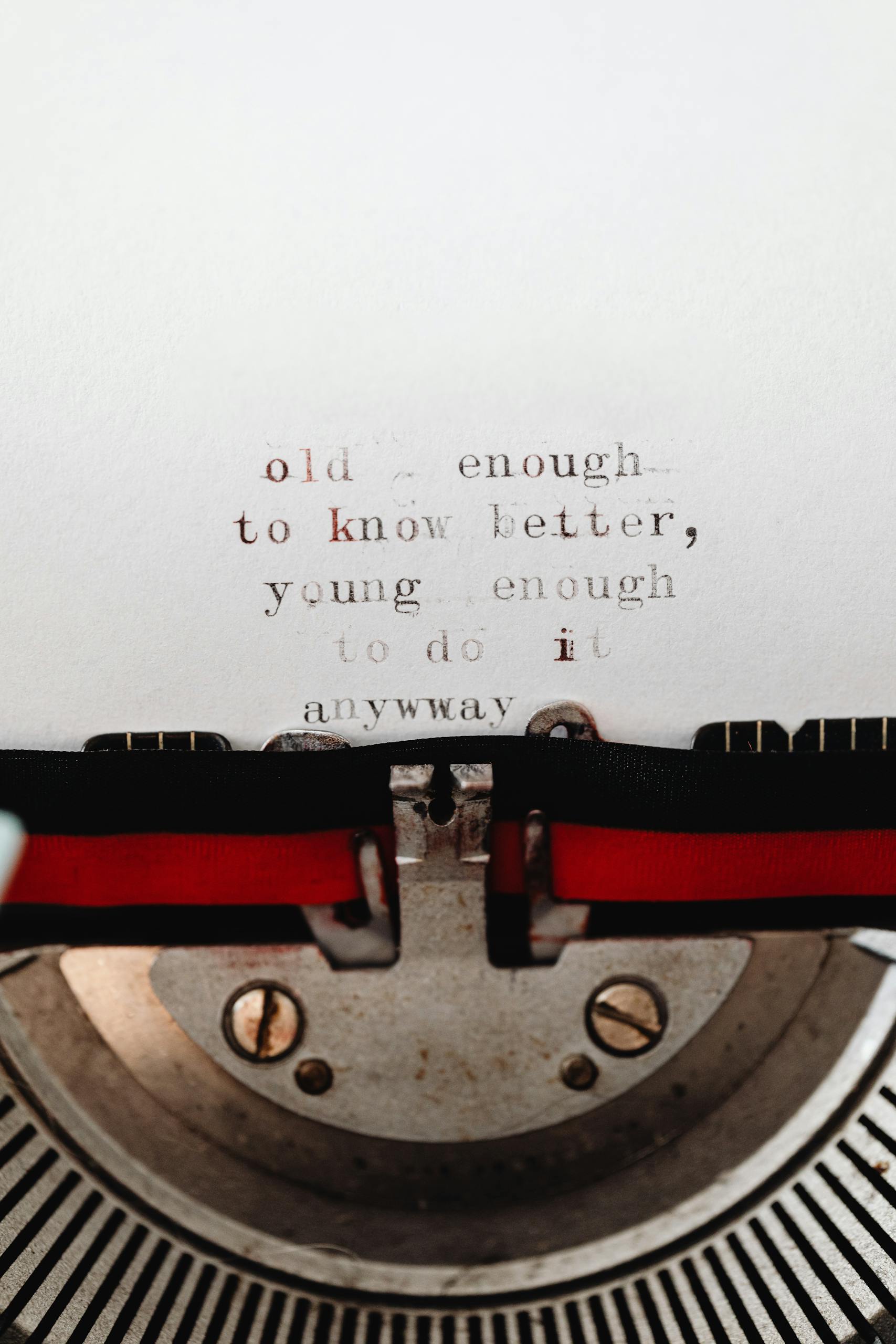 Close-up of a typewriter with an inspirational quote emphasizing youthful spirit and wisdom.